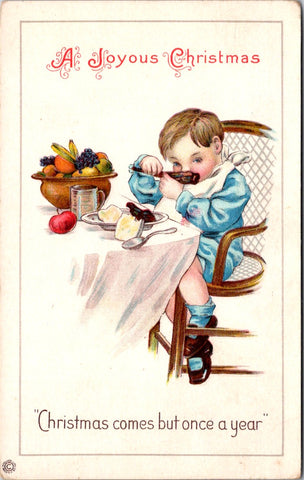 Xmas -  Boy in Blue gnawing of a rib, with a bowl of fruit nearby postcard