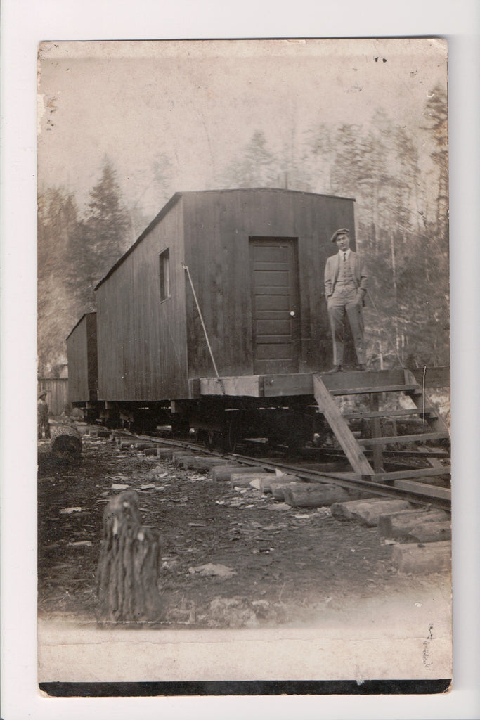 Train - Railroad - stationary cars on hand hewn RR Ties, Man - RPPC - E17042