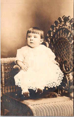 People - Child - sitting on a booster, in a VERY ornate chair RPPC - 800875