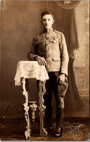 Military Man in uniform - posing with arm on table - RPPC -  B17231