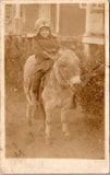 People - Child - sitting on a small donkey RPPC - B17232