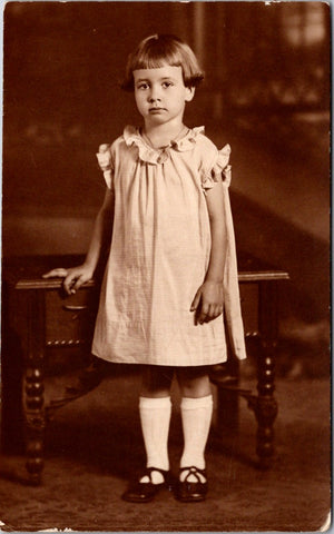 People - Girl - child standing in a plain dress, page boy hair cut RPPC - BP0009