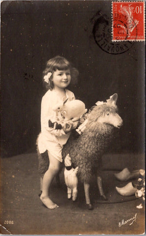 People - Child - barefoot girl sitting on a stuffed sheep holding toys RPPC - BP0100