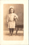 People - Girl - posing while wearing a big bow in her curly hair RPPC - C08355