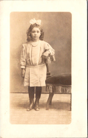 People - Girl - posing while wearing a big bow in her curly hair RPPC - C08355