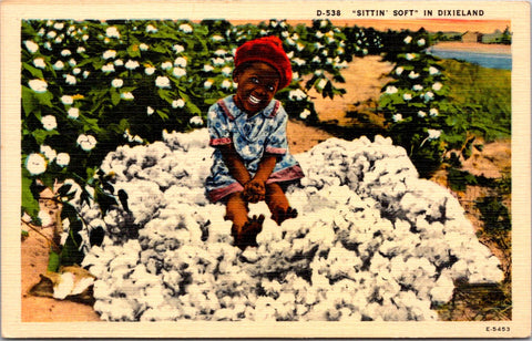 Black Americana - African American child sitting atop a bunch of cotton postcard