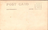 Military Man in uniform - posing in front of a flowing US flag - RPPC - E23237