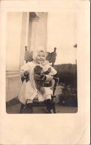 People - Child - sitting in ornate chair with a Steiff teddy bear - RPPC - E23241