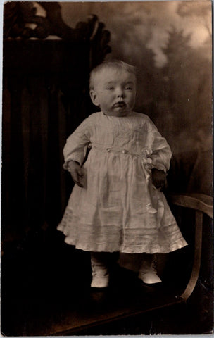 People - Child - standing on ornate chair in dress and boots - RPPC - E23243