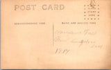 People - Child - sitting, dressed in white with dark button boots - RPPC - E23247