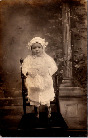 People - Child - standing on chair in white, muff, boots - studio RPPC - F09044