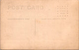 People - Child - sitting on a table holding horse and buggy toy - studio RPPC - F09067