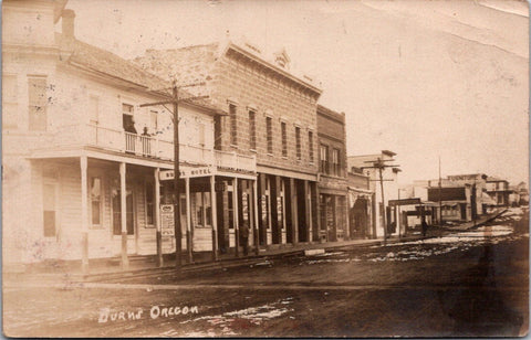 OR, BURNS - Street scene including Stage Office, Burns Hotel - RPPC postcard - F23039