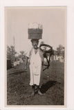 People - Native Dress - Man with container on head with plates? - NL0792
