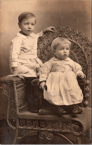 People - Children - posing on ornate wicker chair RPPC - NL0889