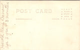 People - Child - sitting - in a white outfit with embroidery - studio RPPC - NL0897