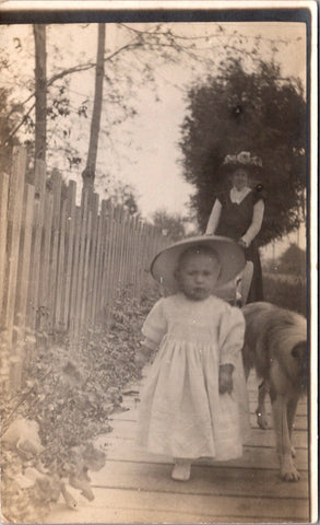 People - Child - Young girl walking, mom with stroller behind, dog on side RPPC - NL0900