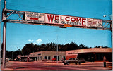 WY, GUERNSEY - Welcome sign over road, Oldsmobile building - NL0933