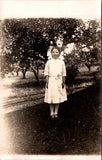 People - Girl - posing in yard dressed in white including bows RPPC - QC0110