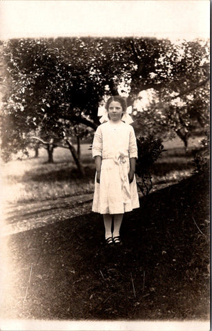 People - Girl - posing in yard dressed in white including bows RPPC - QC0110