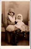 People - Children - cute kids in winter apparel posing on stuffed bench RPPC - S01579