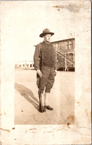 Military Man in uniform - Gun at side, wearing sweater vest - RPPC - W00416