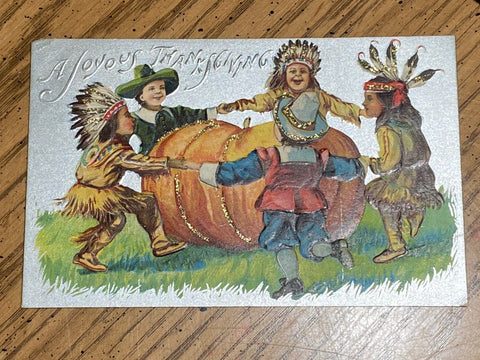 Thanksgiving - Pilgrim and indian kids holding hands around pumpkin - A19128