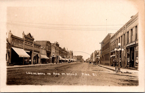 MN, Wells - Main St with signs - RPPC postcard - B18003