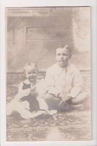 People - Boy barefoot next to little girl holding Kitten - RPPC - W05015